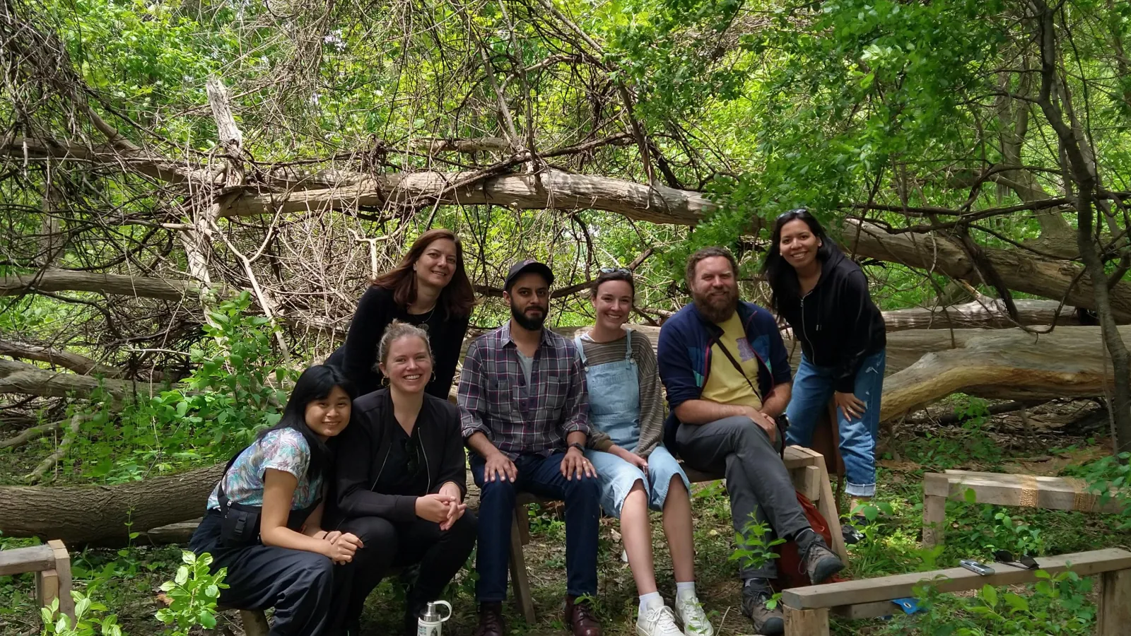 Students and instructor smile at camera in front of the Don River