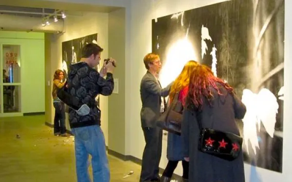 Guests examining art on display