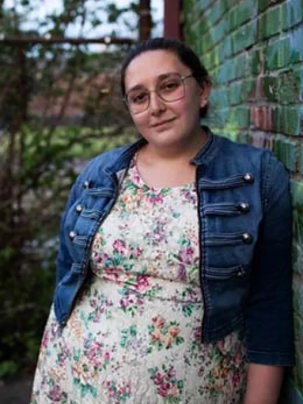 A person leaning against a wall